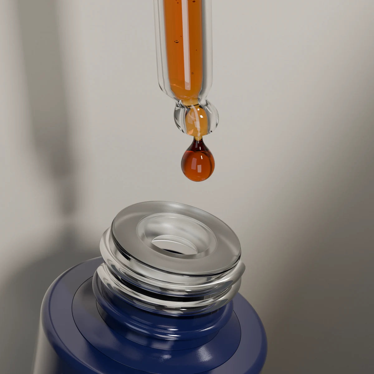 Close-up of an amber-red serum drop at the glass pipette tip above the frosted wiper and open bottle neck.