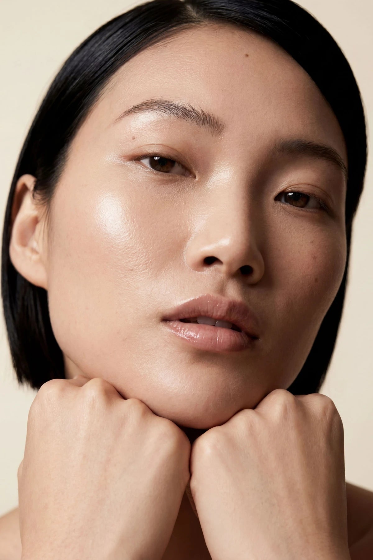 Ritual moment — clean, luminous skin in warm editorial light.