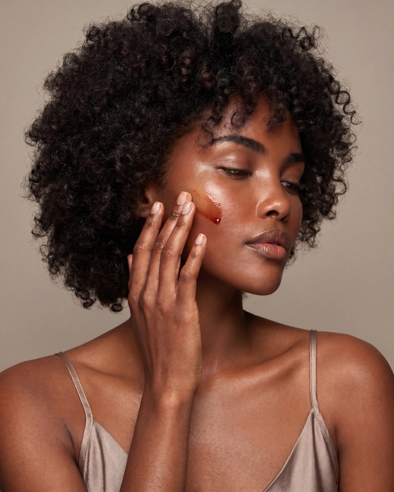 Neogen model pressing the oil-serum into skin — the carrier oils carrying the actives into the complexion.